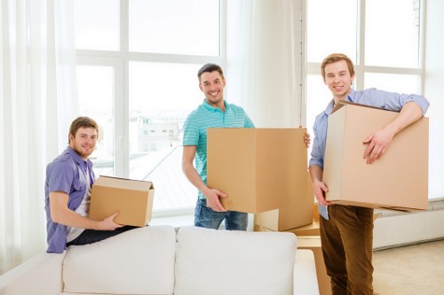 Removal staff in Belsize Park using PPE during a furniture move